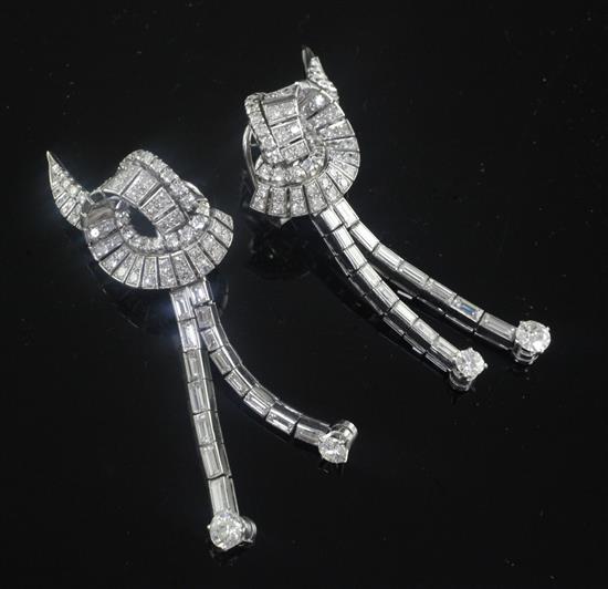 A nice pair of platinum and diamond encrusted scrolling and double drop earrings, 6.5cm.